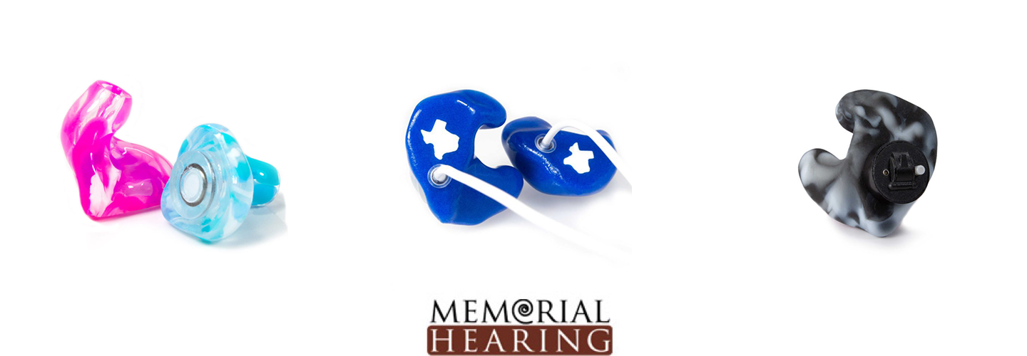 Four different style hearing aids, There two tie dye styled one is pink and the other is light blue tie dye. There is a dark blue one with the State of texas stamped in white on it and another black and white tie dye.