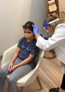 Child receiving a pediatric hearing exam in Houston, TX from Memorial Hearing